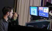 A behind the scenes photo at the roadshow showing audio visual technicians